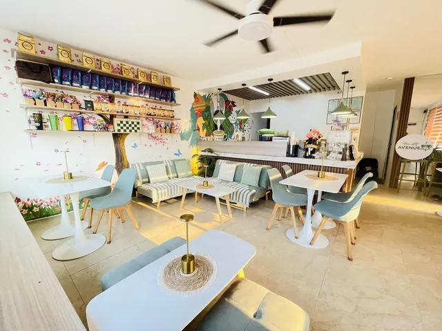 The café interior with aqua chairs, wood shelves and pendant lights