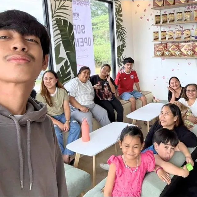 A family hanging out on the sofas inside A’venue Café