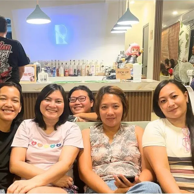 A group of friends smiling together by the counter